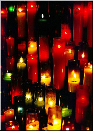 Clusters of votive candles were often set up near holy statues in the cathedral