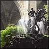 Cathedral cloister fountain. St. George and the dragon rise up out of a huge mound of soft green moss.