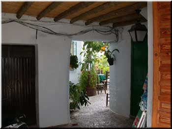 Frigiliana - another doorway. I'm guessing that's the church plaza outside with the outside tables.