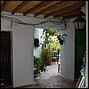 Frigiliana - another doorway. I'm guessing that's the church plaza outside with the outside tables.